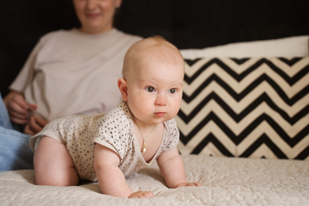 baby crawling on the bed